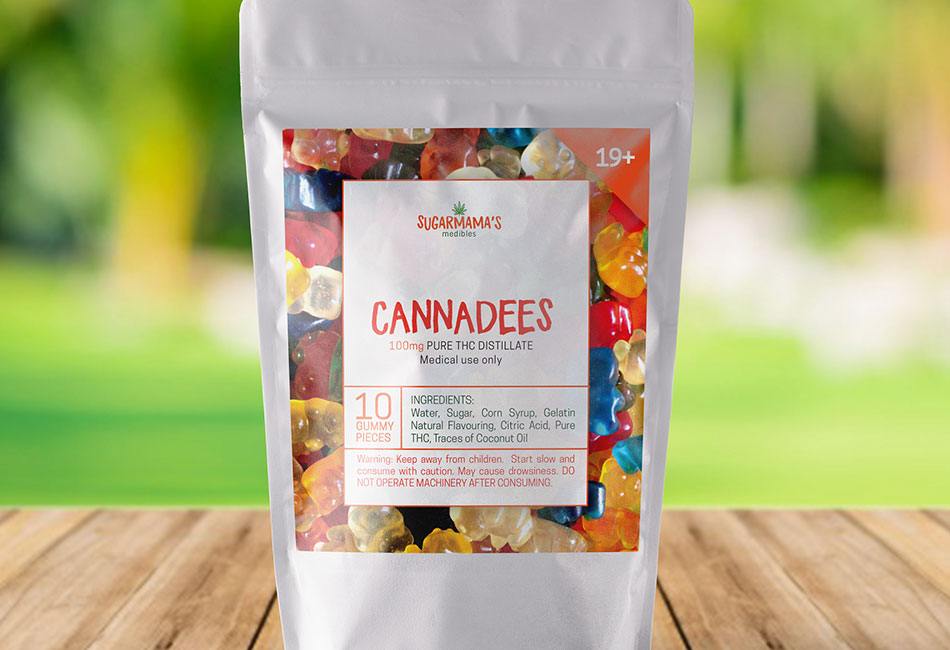 A flexible pack filled with cannabis gummies on a table outdoors with a label on the package